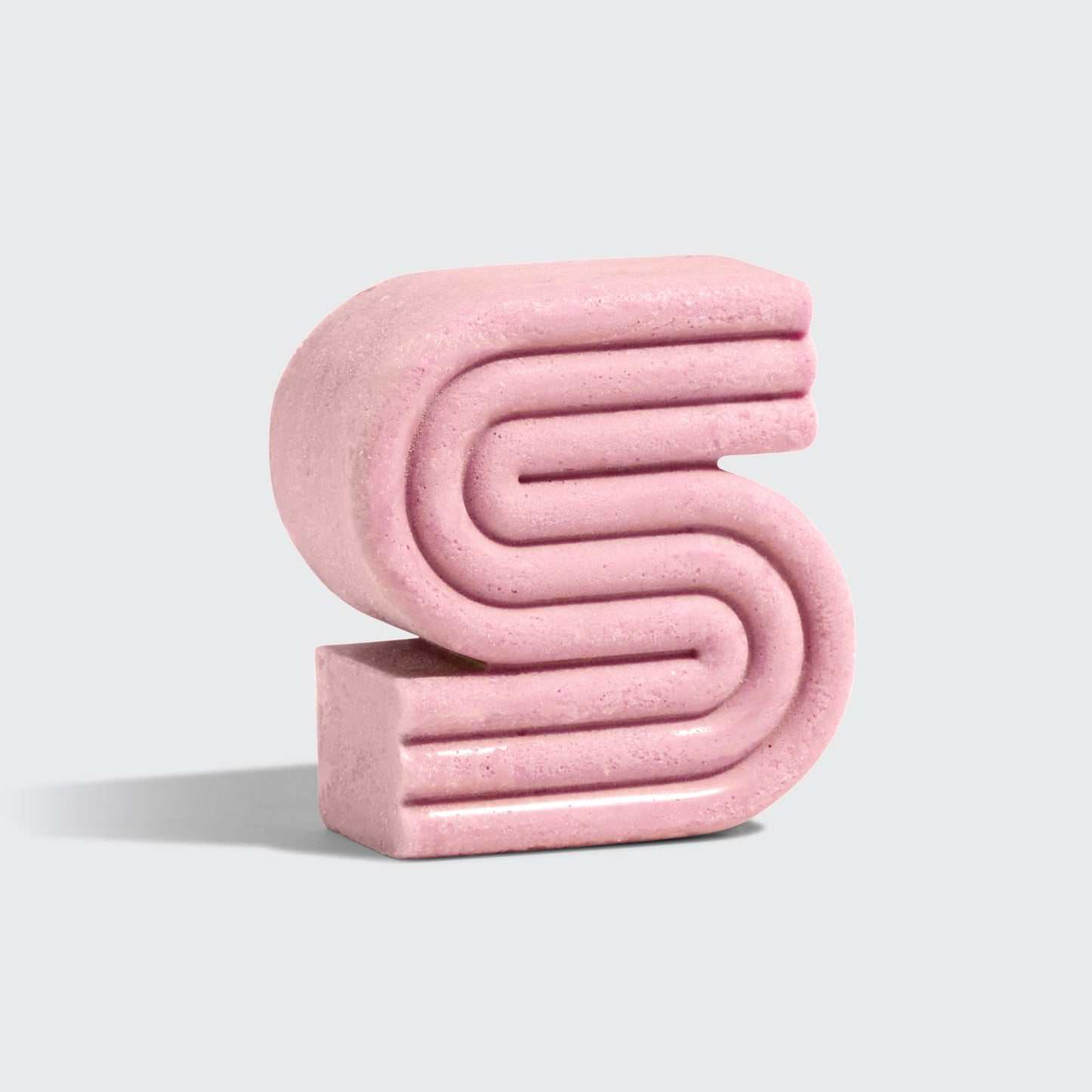 Pink S-shaped Castor Oil Nourishing Shampoo Bar by Kitsch with natural fragrance and eco-friendly design