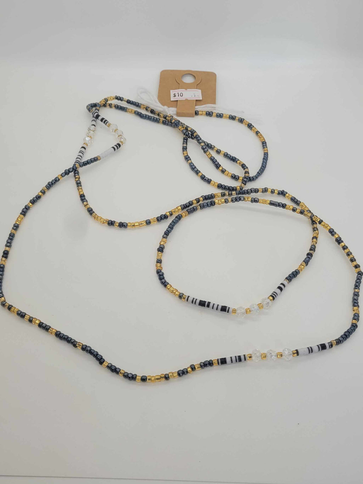 Handmade non stretching waist beads with black, white, and gold glass beads for women