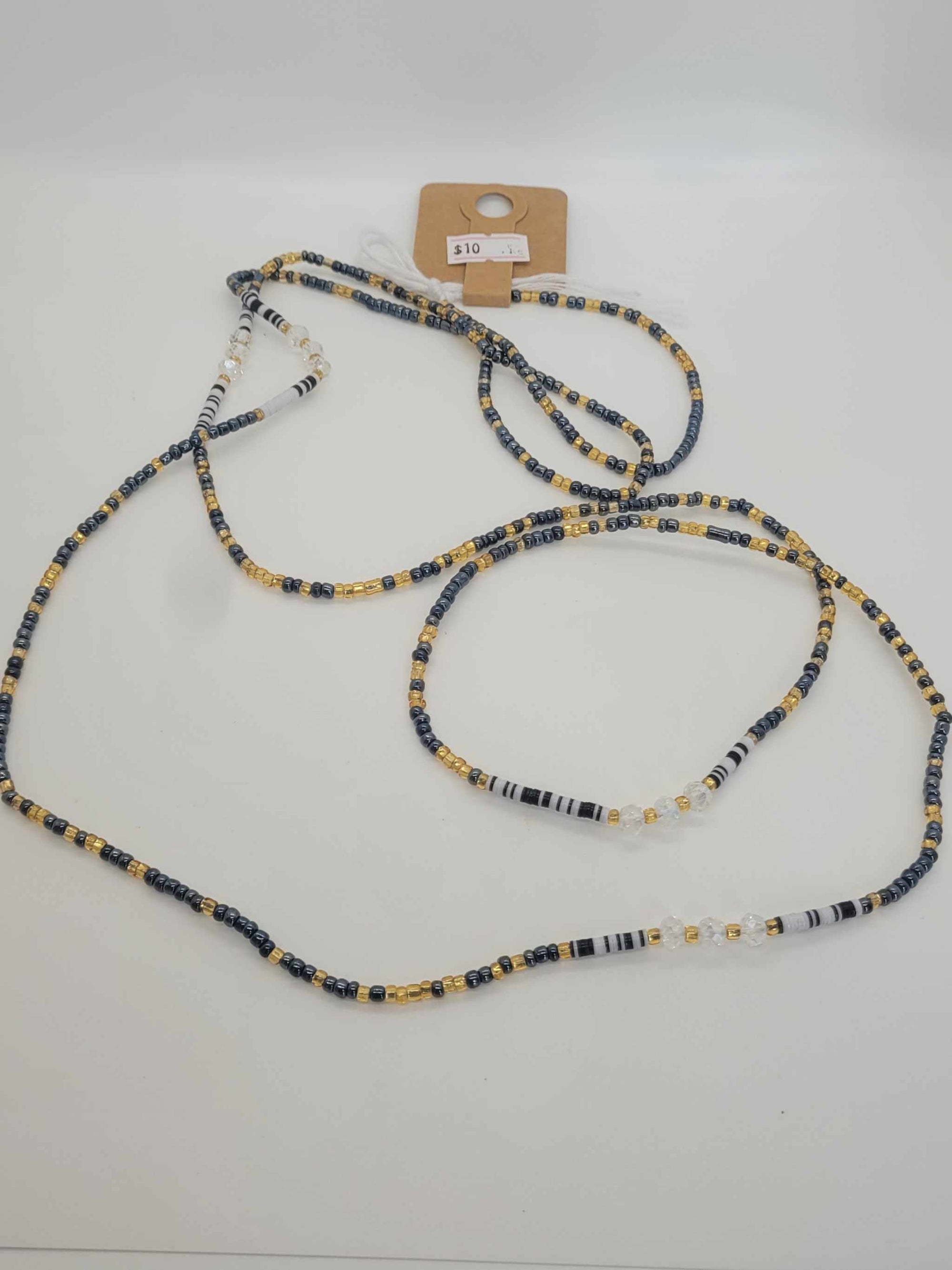 Handmade non stretching waist beads with black, white, and gold glass beads for women