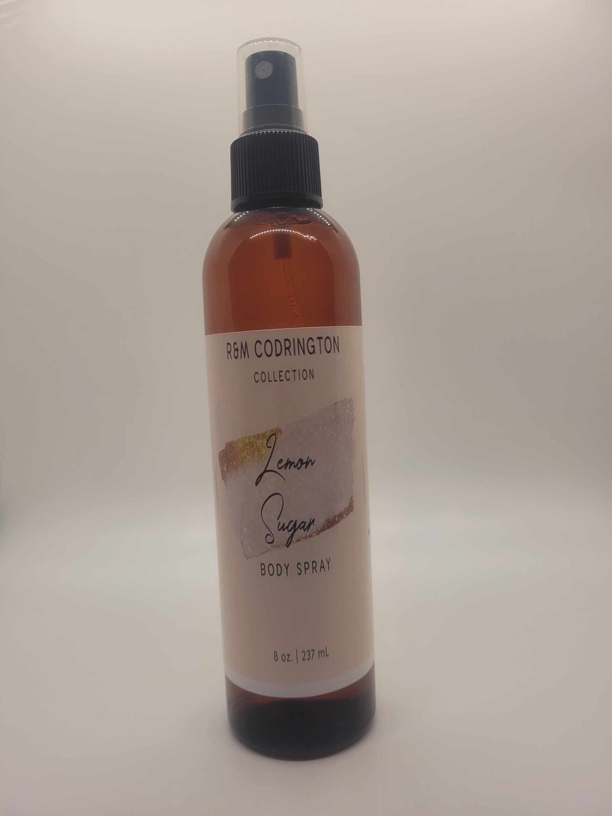 Lemon Sugar Body Spray bottle from P&M Codrington Collection with brown liquid and black spray cap