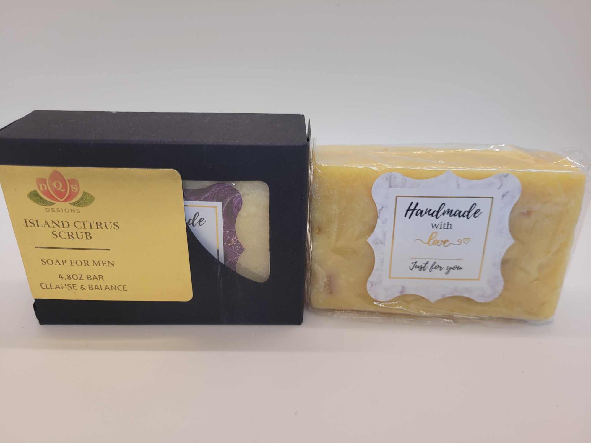 Island Citrus Scrub Soap for men with citrus blend, sea salt, and oatmeal exfoliants in black packaging and yellow soap bar.