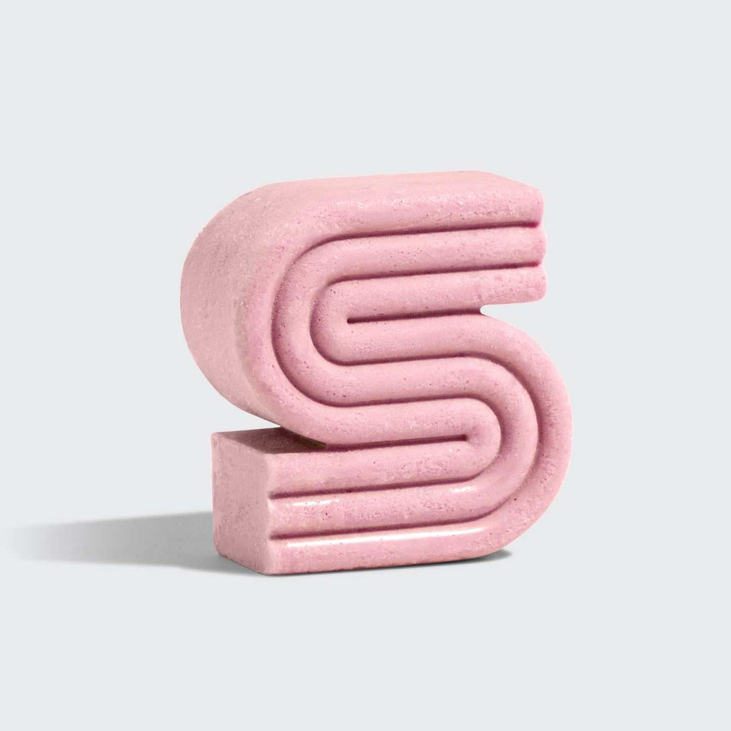 Pink S-shaped Castor Oil Nourishing Shampoo Bar by Kitsch with natural fragrance and eco-friendly design