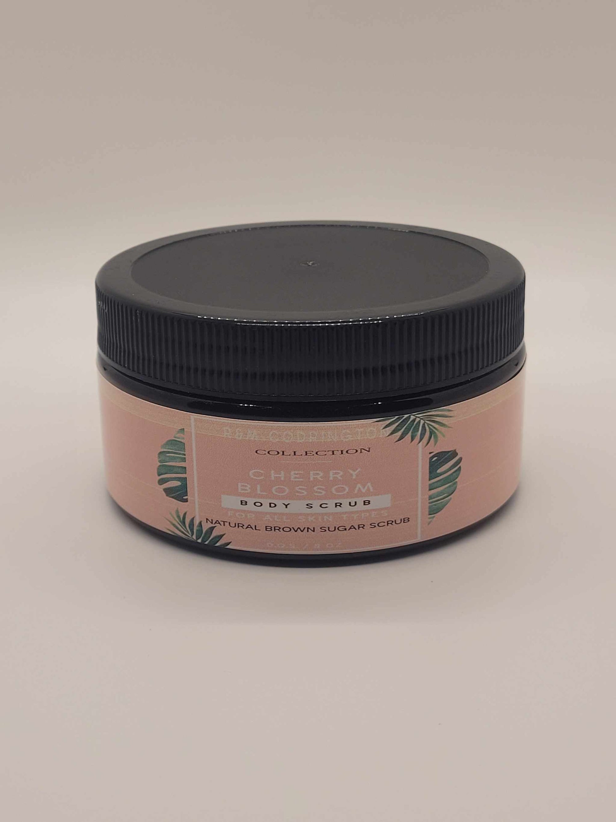 Cherry Blossom Exfoliating brown sugar scrub in an amber jar with black lid