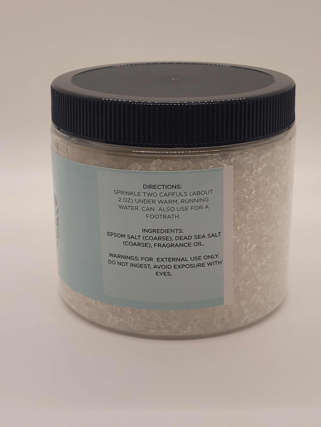 Cherry Blossom Bath Salts jar with coarse Epsom and Dead Sea salts in clear container with black lid
